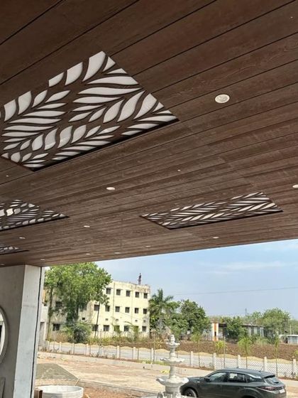 This is not just a ceiling, it's a design statement. We used wooden cladding with backlit CNC-cut panels to create a visually stunning entrance porch.