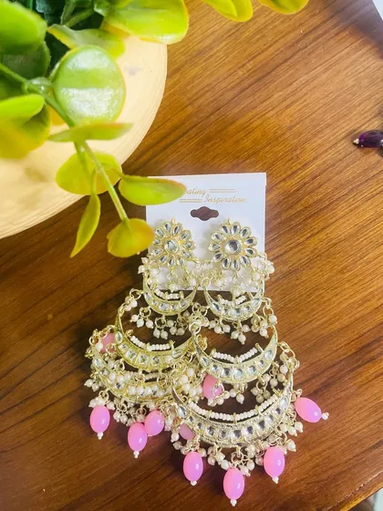 Another look at the light pink tiered chandbalis, showing the detailed craftsmanship and how the layers are constructed with kundan and pearls.