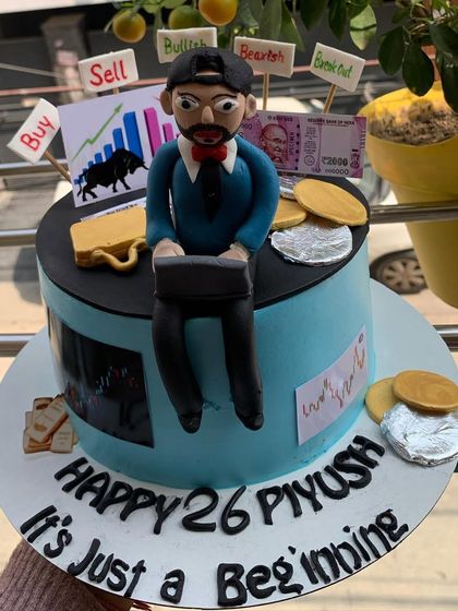 A custom cake for a stock market trader, complete with bulls, bears, and edible money.