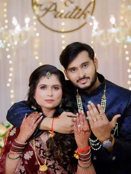 The couple showing off their engagement rings. The bride's makeup is soft yet defined, perfect for the happy occasion.