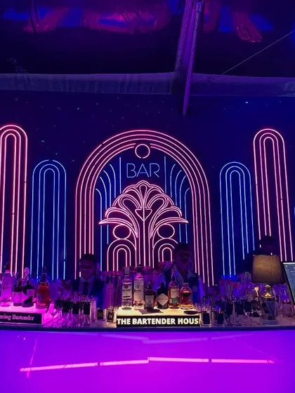 We believe the bar should be a masterpiece. Here’s a look at one of our stunning Art Deco-inspired neon bar setups, designed to be the glowing heart of your celebration.