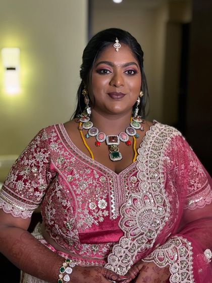 The complete look for this Pondicherry reception. The berry-toned makeup and elegant hairstyle came together to create a look fit for a queen.