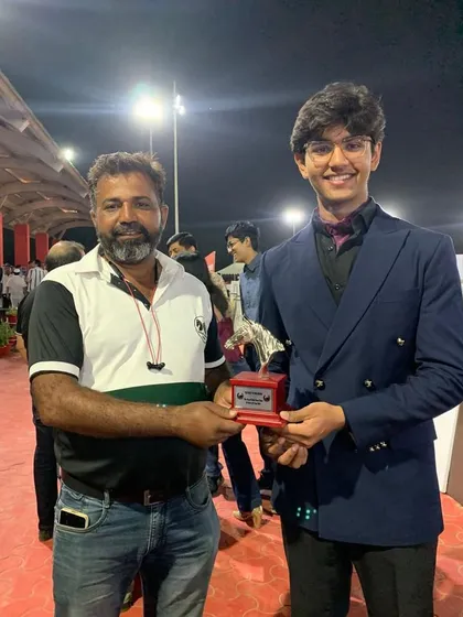 A coach presents a trophy to one of our riders, recognizing him as the Best Rider in his category. We take pride in acknowledging the hard work of our students.