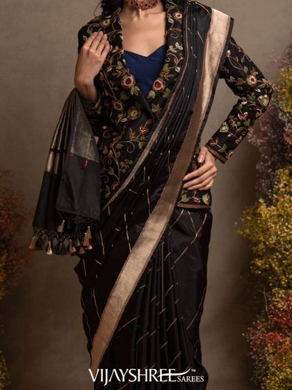 A modern interpretation of Banarasi silk, this black saree with abstract geometric weaving is paired with a stylish embroidered jacket.