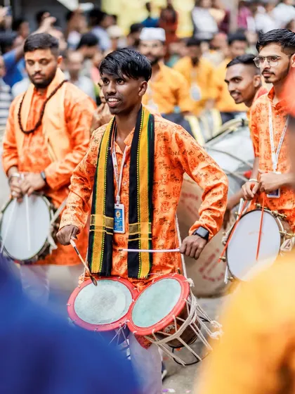 The color version of the smiling tasha player, the orange uniforms adding to the festive atmosphere.