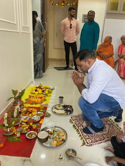 A moment of prayer at a Griha Pravesh puja. These ceremonies are fundamental to our service, ensuring the home is spiritually cleansed and ready for the family.