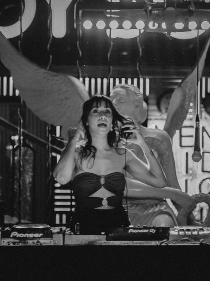 Another artistic black and white photo, adjusting my headphones. The angel wings in the background add a cool, dramatic touch to the scene.