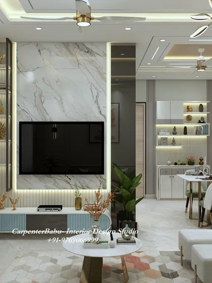 A living room where the TV unit is the star. The marble back panel is framed by backlit display shelves, and the hexagonal-patterned rug adds a modern geometric touch.