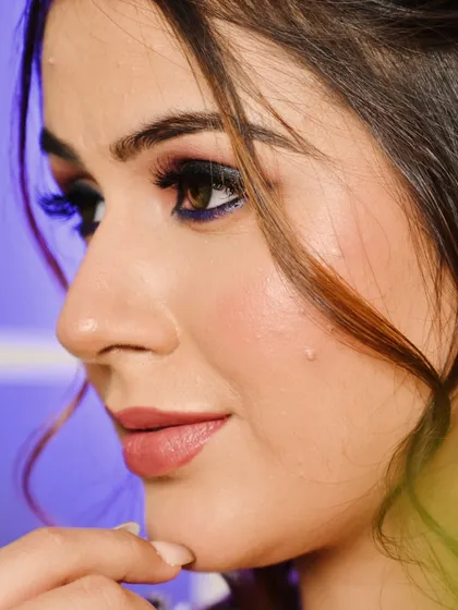 A side profile showing the flawless skin texture and soft contour. This highlights my belief in enhancing, not hiding, and creating a skin-like finish that looks beautiful up close.
