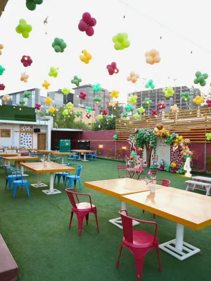I can turn our spacious outdoor lawn into any world you can imagine. Here, we created a colorful safari-themed party, complete with themed seating and balloons floating like a canopy, ready for a wild celebration.