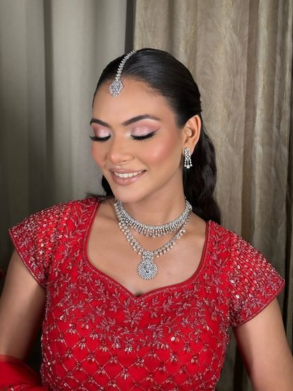 A close-up of Komal's soft glam makeup. The pink eyeshadow and glowing skin are perfect for an engagement ceremony.