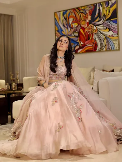A full-length portrait showcasing the beautiful pink lehenga and the makeup that completes the look.