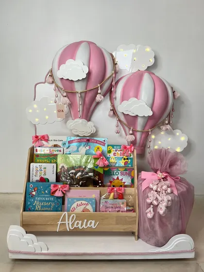 This view showcases the soft lighting from the cloud decorations, adding a warm and comforting glow to the entire hot air balloon themed gift hamper.