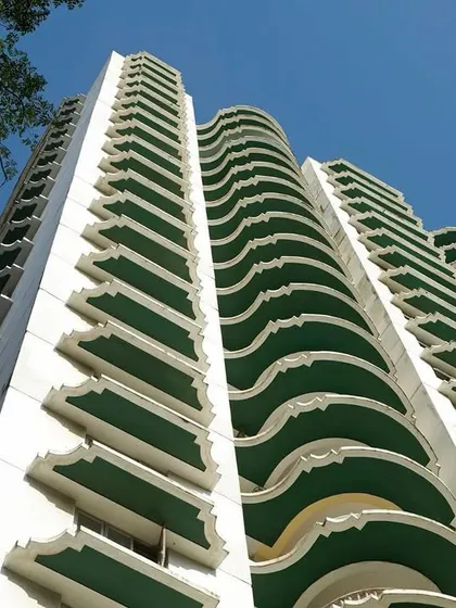 The facade of the Buena Vista Apartments is defined by its distinctive scalloped balconies. This rhythmic, curvilinear element gives the building a unique identity and a sense of graceful movement.