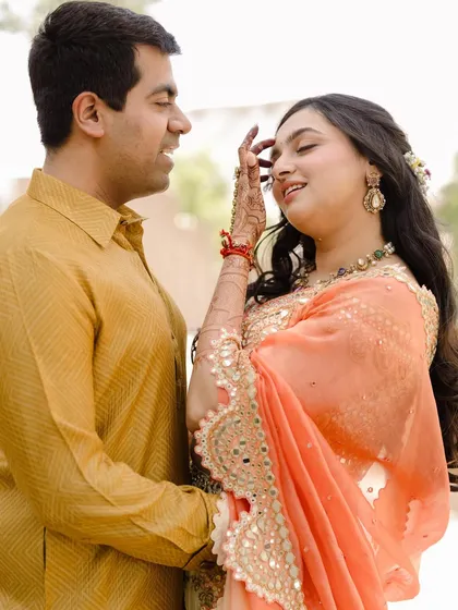 A gentle touch and a soft smile. This close-up captures the tender details and emotions during a vibrant pre-wedding shoot at Fairmont Jaipur.