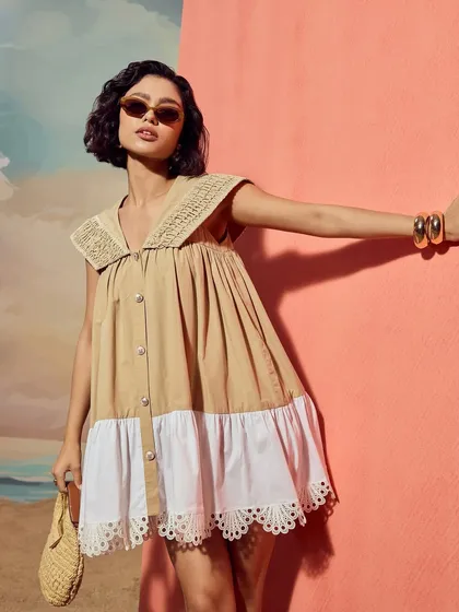 A close-up shot of the Sand Sailor Dress from Qala Clothing, highlighting the texture of the fabric and the detailed collar.