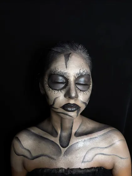 A creative makeup demo featuring a skeletal, tribal-inspired look. This showcases the contouring and line work skills taught in our advanced modules.