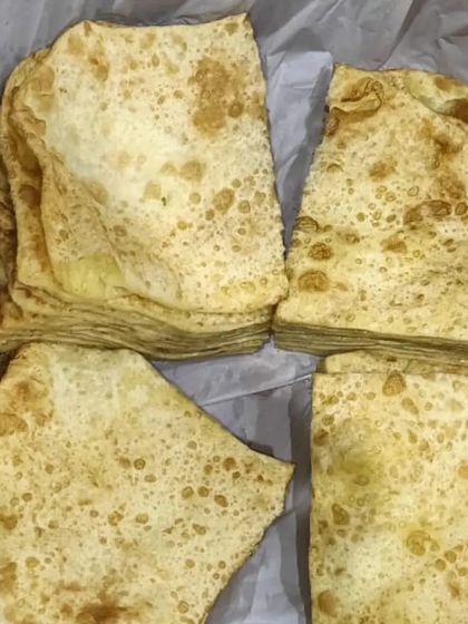 Stacks of soft, layered Rumali Roti, ready to be packed. They are the perfect bread to scoop up my rich and flavourful curries.