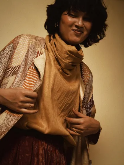 A playful and candid moment from a studio shoot with House of Wandering Silk, showcasing the texture and drape of the clothing.