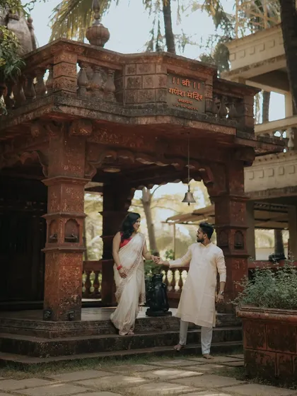 A moment of invitation and togetherness at the temple entrance. This shot from their Alibaug pre-wedding session is full of grace and traditional charm.