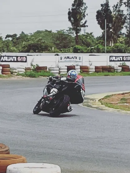 A rider leans into a corner at Aruani Grid. This controlled environment allows you to explore the limits of your bike and your ability without the dangers of public roads.
