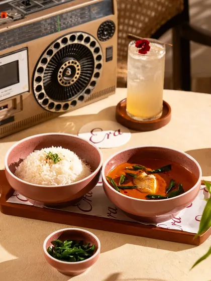 A simple, comforting meal of fish curry and rice. The retro styling with the boombox gives it a cool, nostalgic vibe.