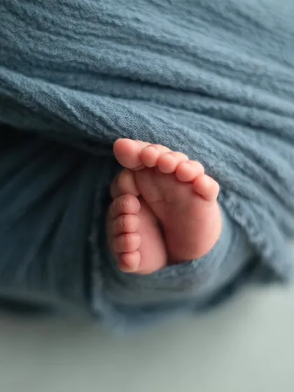 I focus on capturing all the teeny tiny details that change so quickly. These perfect little toes, peeking out of a soft wrap, are a beautiful reminder of just how small they once were.