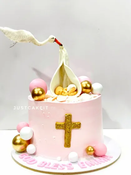 A different take on the gravity-defying Baptism cake, this one in pink for a baby girl. The delicate, hand-sculpted stork is the centerpiece of this special occasion cake.