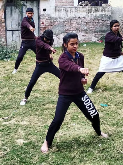 A group of my young female students practicing their stances during an outdoor training session. Together, they build not just individual skill but a community of support and shared strength. This is what building confidence through martial arts looks like.