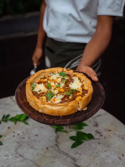 A freshly baked Puffizza is served, its golden crust and savory aroma filling the air.