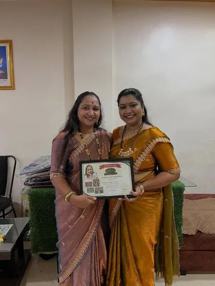 A proud moment, awarding a certificate to a successful student. She is now ready to start her own floral jewellery business.