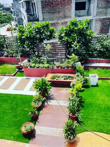 This terrace garden design incorporates raised planters and a small pond, creating different levels and points of interest.