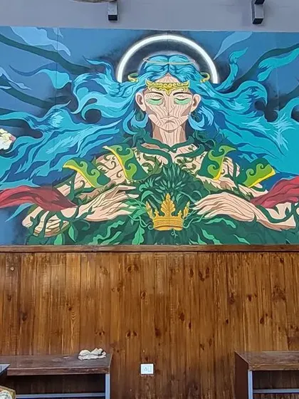The full view of our "Mother Nature" mural inside the Cuppa cafe in Mysore. The artwork spans the wall, creating an epic, mythic atmosphere that completely transforms the space and provides a stunning visual focus.