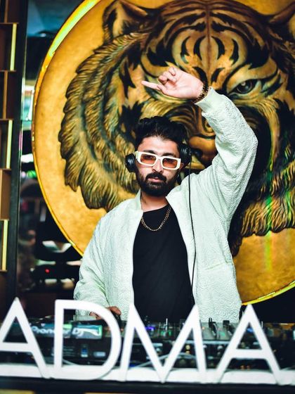 Hand up, signaling the drop at Badmaash. The energy is building.