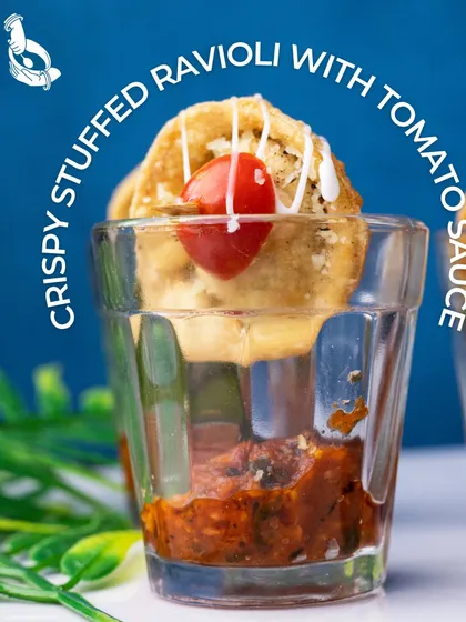 A playful and delicious appetizer. My Crispy Stuffed Ravioli is served in a shot glass over a slow-cooked tomato relish, creating a delightful contrast of textures and flavors that is always a crowd-pleaser at house parties and informal corporate events.