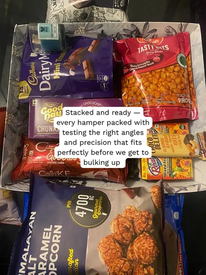 Stacking and arranging with precision. We test the placement of every item to ensure the hampers are packed perfectly before we begin the bulk assembly.