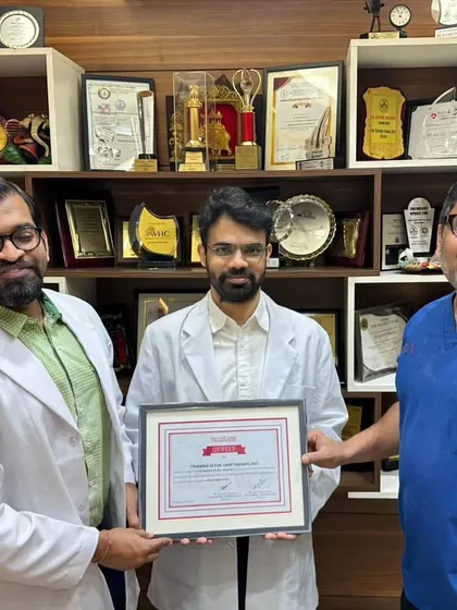 Another shot of Dr. Reddy's certificate presentation, with my wall of awards in the background, symbolizing our commitment to excellence.