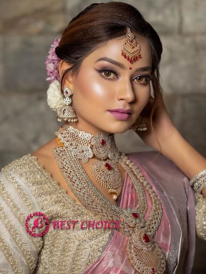 A close-up portrait highlighting the beautiful makeup and the intricate details of our ruby and diamond-look choker and jhumkas.