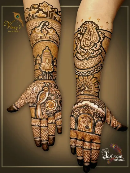 An asymmetrical design for the groom's sister, with each hand telling a different story. One hand has a parrot and elephants, while the other features a peacock and an elephant portrait.