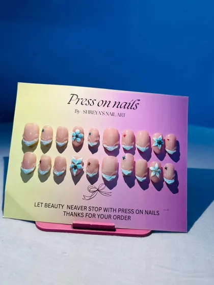 I love working with 3D elements to make the nail art pop. This set features delicate, hand-sculpted shell flowers on a French manicure base, perfect for a beach vacation or a unique summer look.