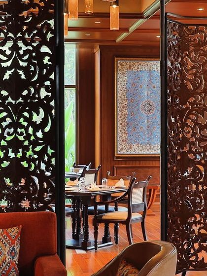 An elegant textile installation by artist Sachin Deo, titled 'Chime', at the Zarf restaurant in Sheraton Grand. This 15-foot wall art creates a sophisticated and culturally rich dining environment.