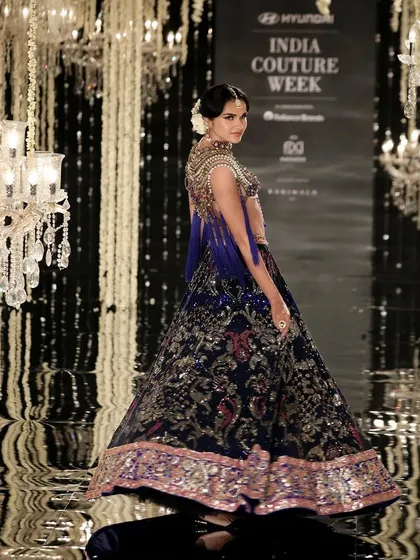 Another look from the Suneet Varma show at India Couture Week. The model's makeup is elegant and timeless, pairing perfectly with the royal blue and gold couture lehenga.