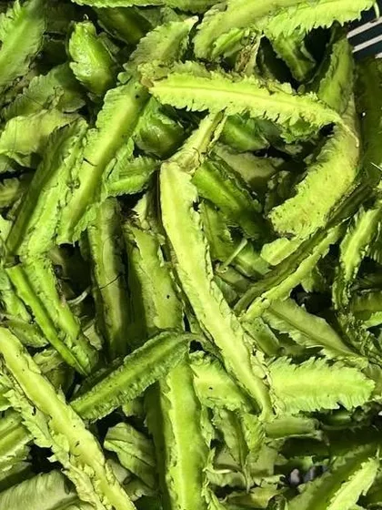 Chopped winged beans, ready to be cooked. This vegetable has a unique shape and a crunchy texture, popular in salads and stir-fried dishes.