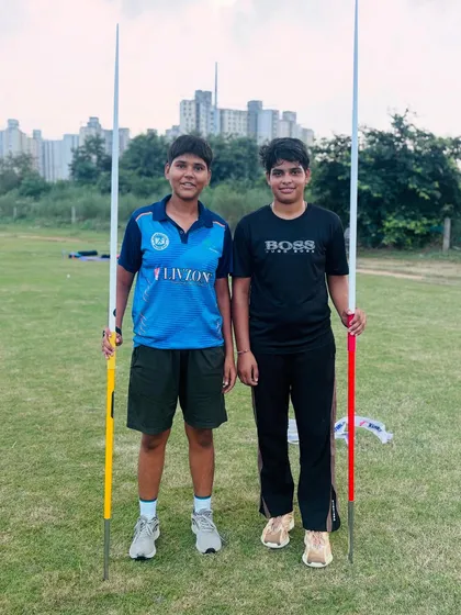 We build powerful throwers. Two of our dedicated javelin athletes posing with their equipment during a training session. We focus on developing both raw power and precise throwing technique.