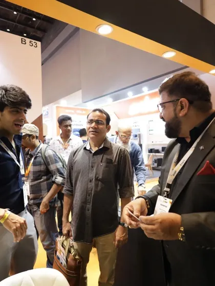 An exhibitor shares a business card with an interested attendee, a classic yet vital part of the networking and lead generation process at our B2B event.