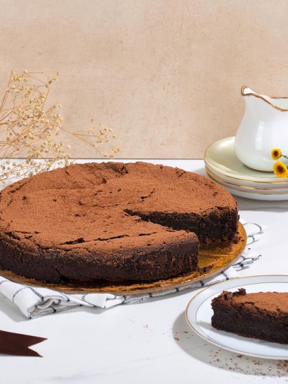 My Gluten-Free Dark Chocolate Cake is ultra-chocolatey and fudgy. I can also make it with jaggery instead of sugar upon request.