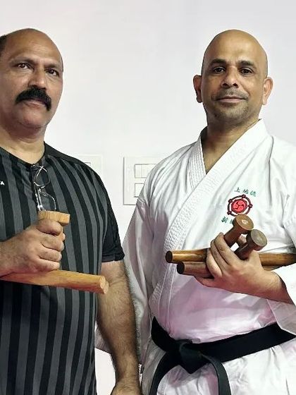 Holding the Tonfa and Nunchaku with Sensei Jabir. Sharing knowledge with other experienced instructors enriches our entire dojo.