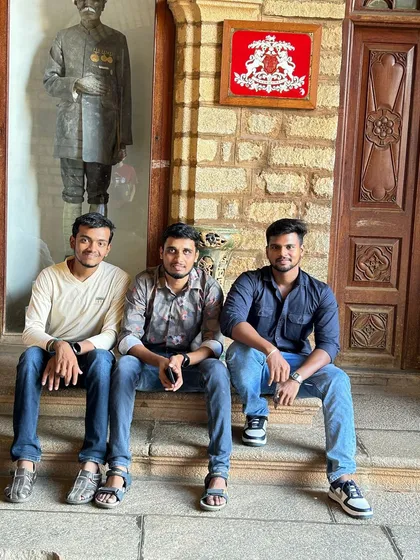 A group photo inside the palace, showcasing the traditional stone and wood interiors.
