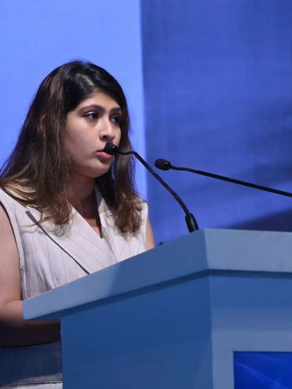 A speaker presents her insights from the podium, contributing to the diverse range of voices at our conference.