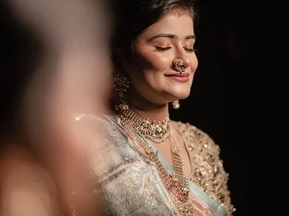 A serene moment for the bride. The makeup is soft and glowing, creating a look of timeless elegance.